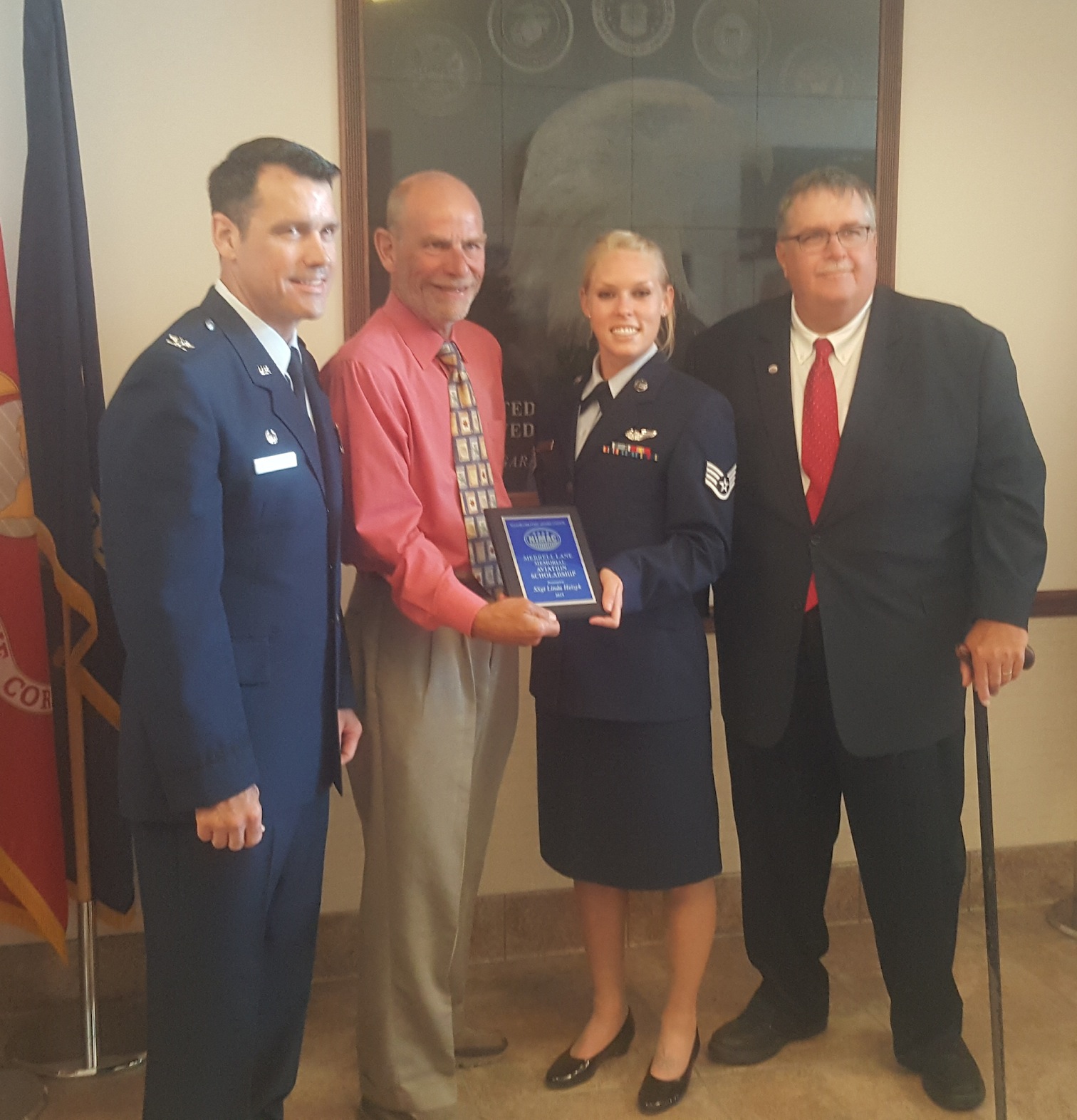 Staff Sergeant Linda Heizyk is awarded the 2019 Merrell Lane Memorial Aviation Scholarship. From left, 914th Air Refueling Wing Vice Commander Col. Erik Aufderheide, Col. Kurt Hammer, Heizyk and NIMAC Chairman John Cooper.